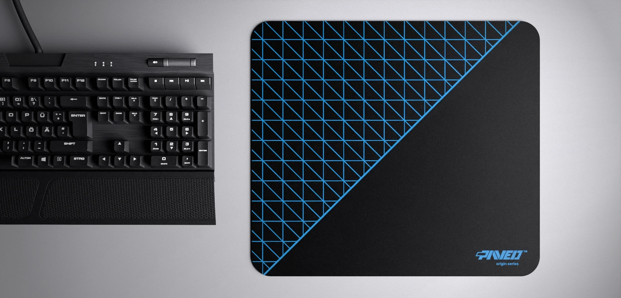 Top view of Night Sky Net Runner M size mousepad 360mm x 320mm right-handed variant with dense geometric net pattern in blue and black, hydrophobic easy-to-clean surface with antimicrobial properties, shown with full-size mechanical keyboard for scale, 600% lighter with no rubbery odour base, durable stitch-free finish.