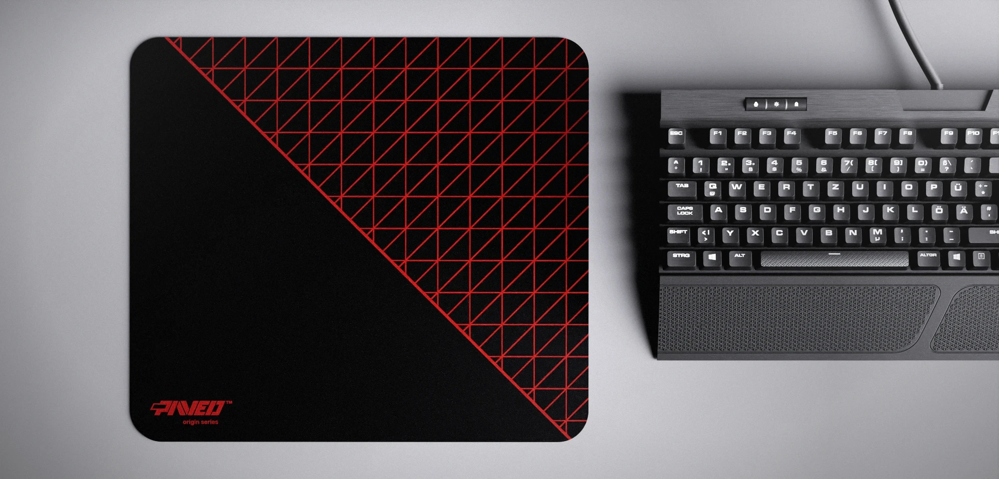 Top view of Night Imperial Net Runner M size mousepad 360mm x 320mm left-handed variant with minimalistic red dense geometric net pattern on black background, water-resistant antimicrobial polyester surface, shown with full-size mechanical keyboard for scale, ultra-lightweight odour-free AreoFlex base, stitch-free edges.