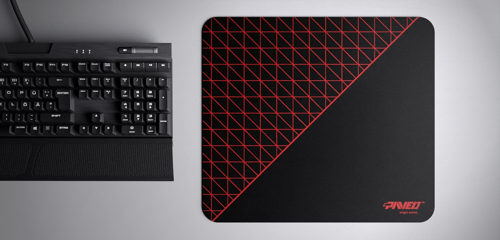 Top view of Night Imperial Net Runner M size mousepad 360mm x 320mm right-handed variant with dense geometric net pattern in red and black, hydrophobic easy-to-clean surface with antimicrobial properties, shown with full-size mechanical keyboard for scale, 600% lighter with no rubbery odour base, durable stitch-free finish.