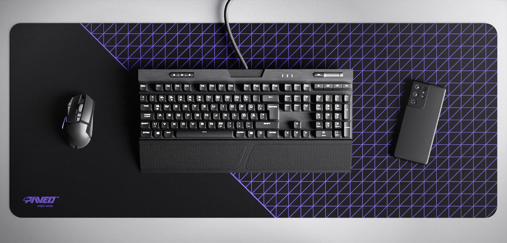 Top view of Night Amethyst Net Runner XXL deskmat 1000mm x 400mm left-handed variant featuring dense geometric net pattern in purple and black, water-resistant antimicrobial polyester surface, shown with full-size mechanical keyboard, gaming mouse, and smartphone for scale, ultra-lightweight odour-free AreoFlex microruber base, stitch-free professional finish.