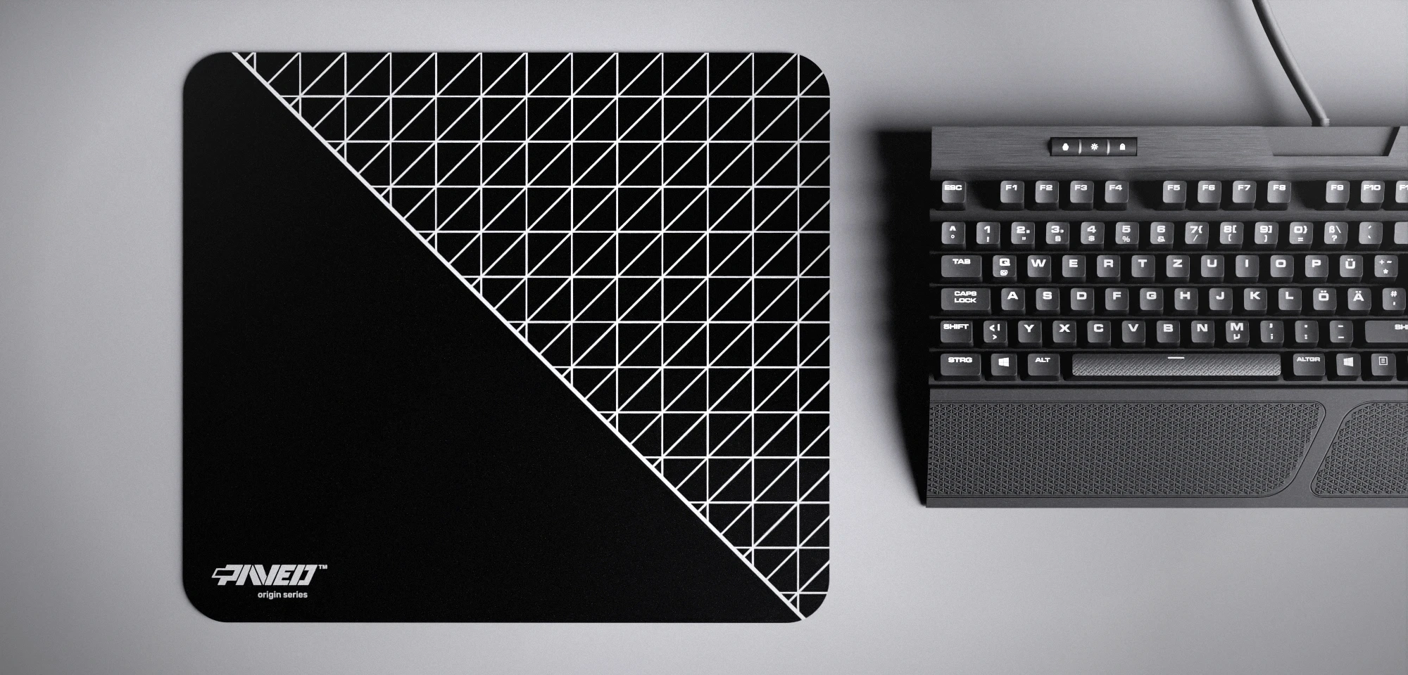 Top view of Night Net Runner M size mousepad 360mm x 320mm left-handed variant with minimalistic white dense geometric net pattern on black background, water-resistant antimicrobial polyester surface, shown with full-size mechanical keyboard for scale, ultra-lightweight odour-free AreoFlex base, stitch-free edges.