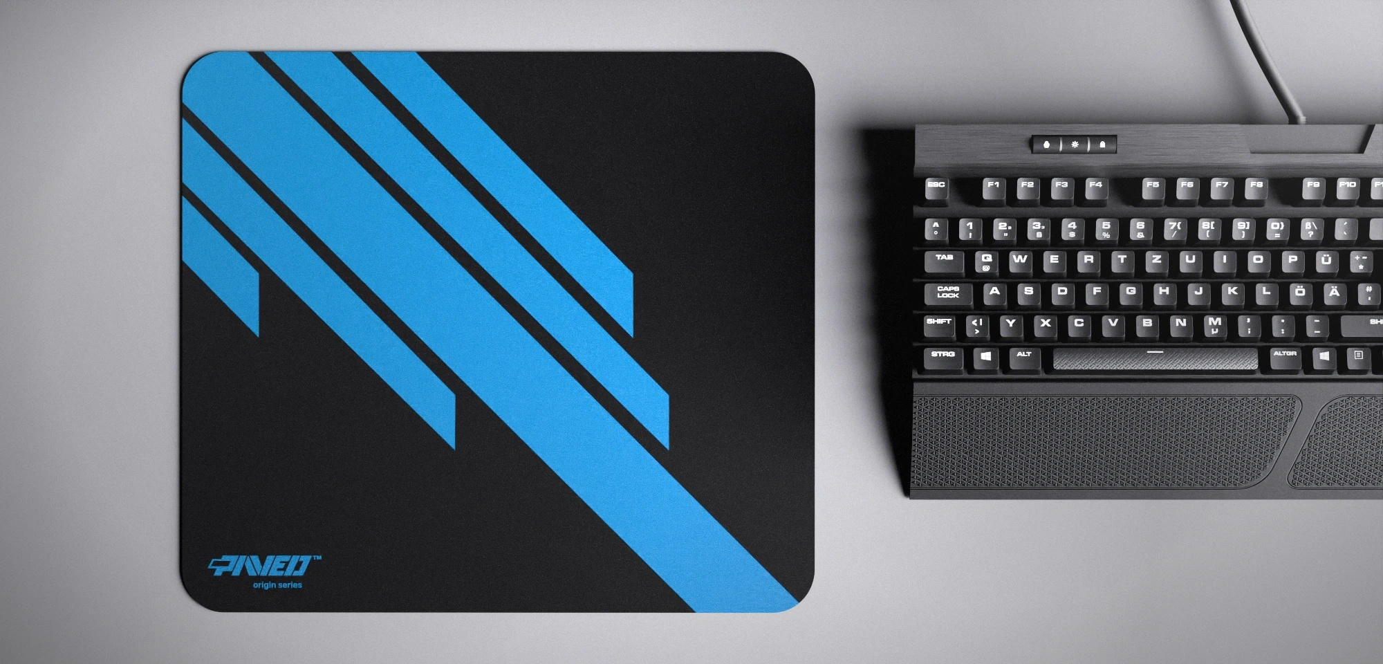 Top view of Night Sky Blade Runner M size mousepad 360mm x 320mm left-handed variant with minimalistic blue diagonal stripe design on black background, water-resistant antimicrobial polyester surface, shown with full-size mechanical keyboard for scale, ultra-lightweight odour-free AreoFlex base, stitch-free edges.
