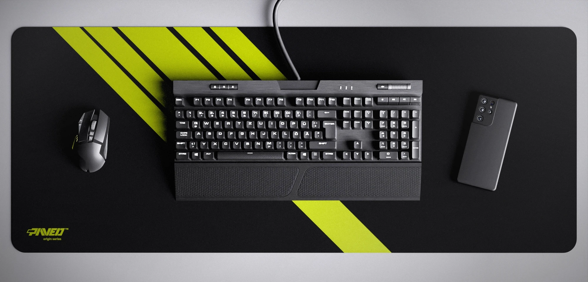 Top view of Night Toxic Blade Runner XXL deskmat 1000mm x 400mm left-handed variant featuring diagonal stripe design in light green and black, water-resistant antimicrobial polyester surface, shown with full-size mechanical keyboard, gaming mouse, and smartphone for scale, ultra-lightweight odour-free AreoFlex microruber base, stitch-free professional finish.