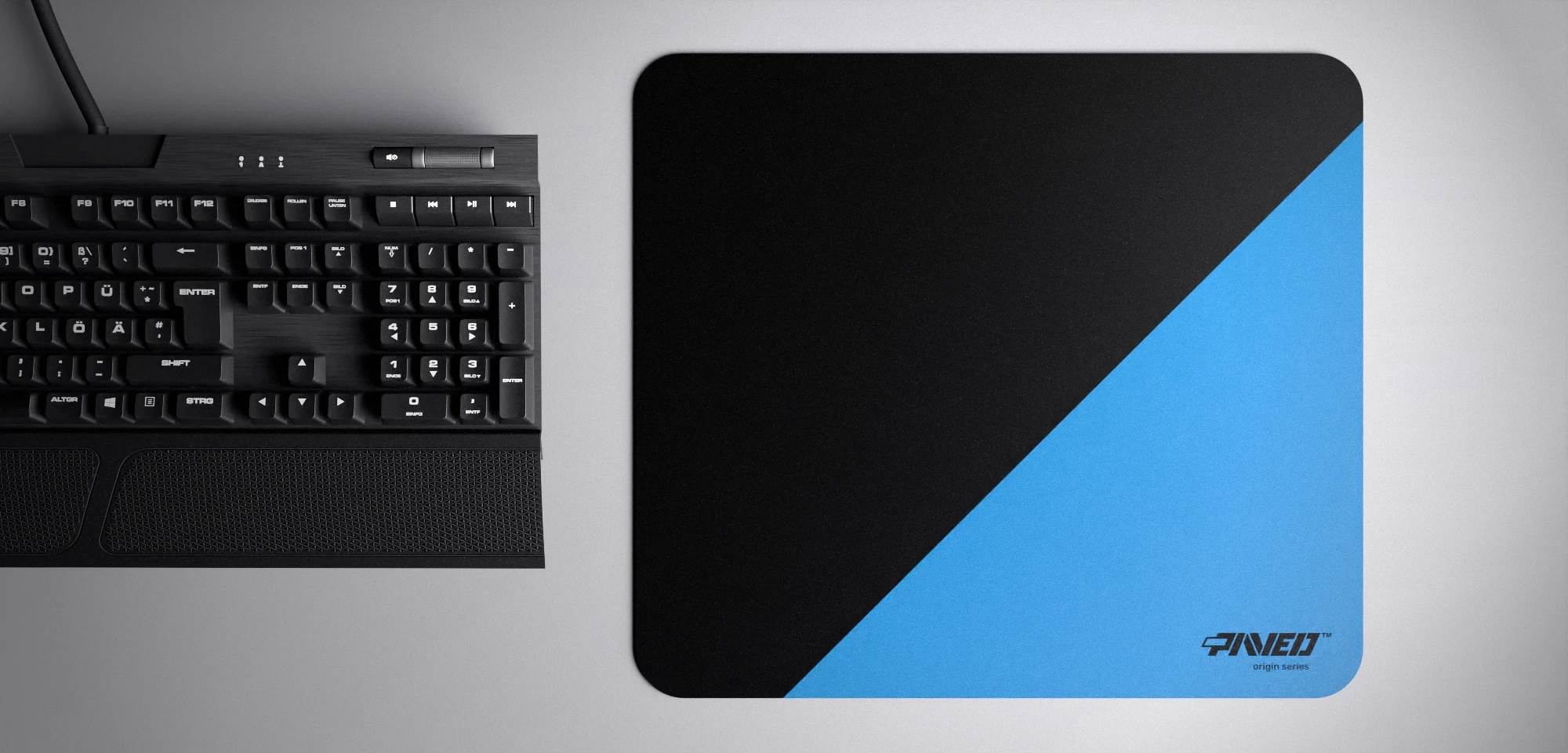 Top view of Sky Edge Runner M size mousepad 360mm x 320mm right-handed variant with diagonal split design in blue and black, hydrophobic easy-to-clean surface with antimicrobial properties, shown with full-size mechanical keyboard for scale, 600% lighter with no rubbery odour base, durable stitch-free finish.