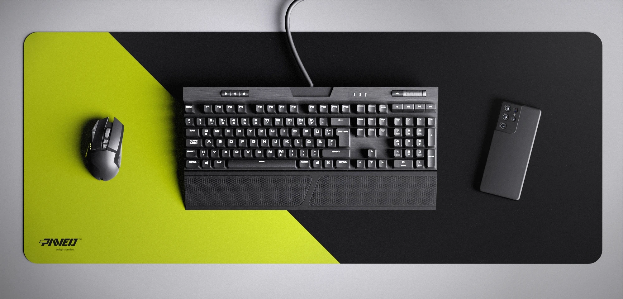 Top view of Toxic Edge Runner XXL deskmat 1000mm x 400mm left-handed variant featuring diagonal split design in light green and black, water-resistant antimicrobial polyester surface, shown with full-size mechanical keyboard, gaming mouse, and smartphone for scale, ultra-lightweight odour-free AreoFlex microruber base, stitch-free professional finish.