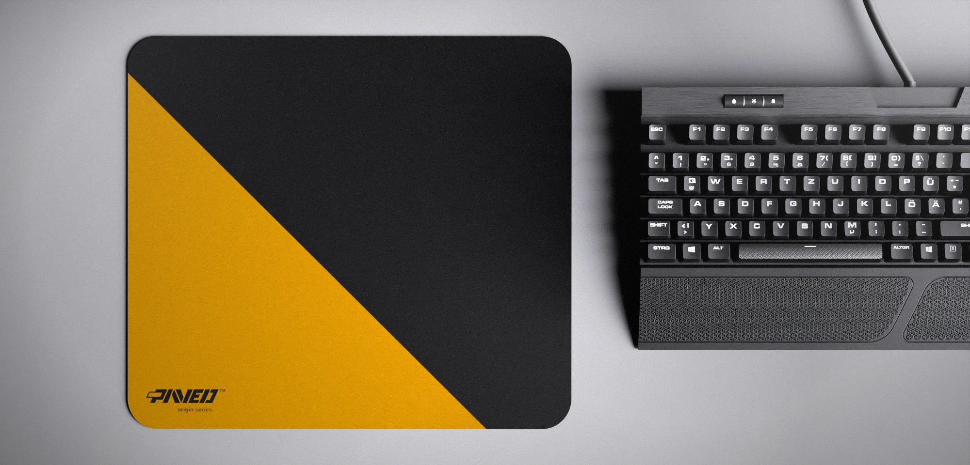 Top view of Desert Edge Runner M size mousepad 360mm x 320mm left-handed variant with minimalistic deep yellow diagonal split design on black background, water-resistant antimicrobial polyester surface, shown with full-size mechanical keyboard for scale, ultra-lightweight odour-free AreoFlex base, stitch-free edges.