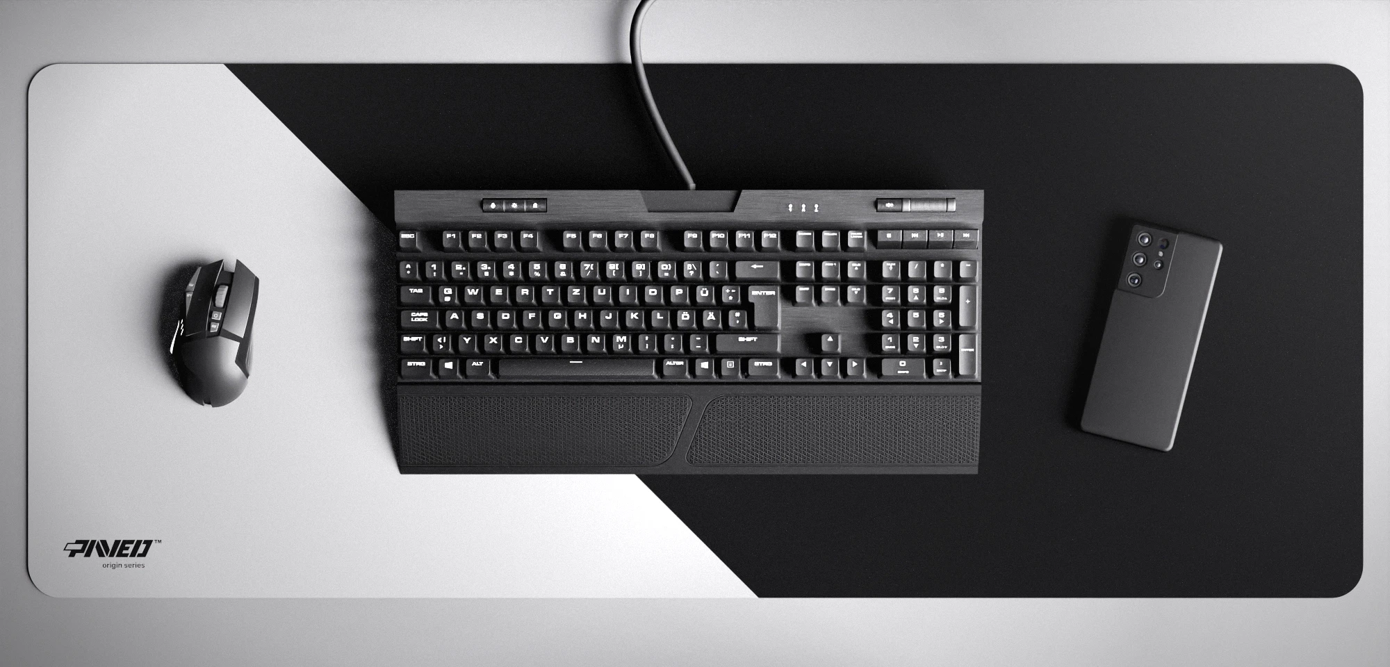 Top view of Polar Edge Runner XXL deskmat 1000mm x 400mm left-handed variant featuring diagonal split design in white and black, water-resistant antimicrobial polyester surface, shown with full-size mechanical keyboard, gaming mouse, and smartphone for scale, ultra-lightweight odour-free AreoFlex microruber base, stitch-free professional finish.