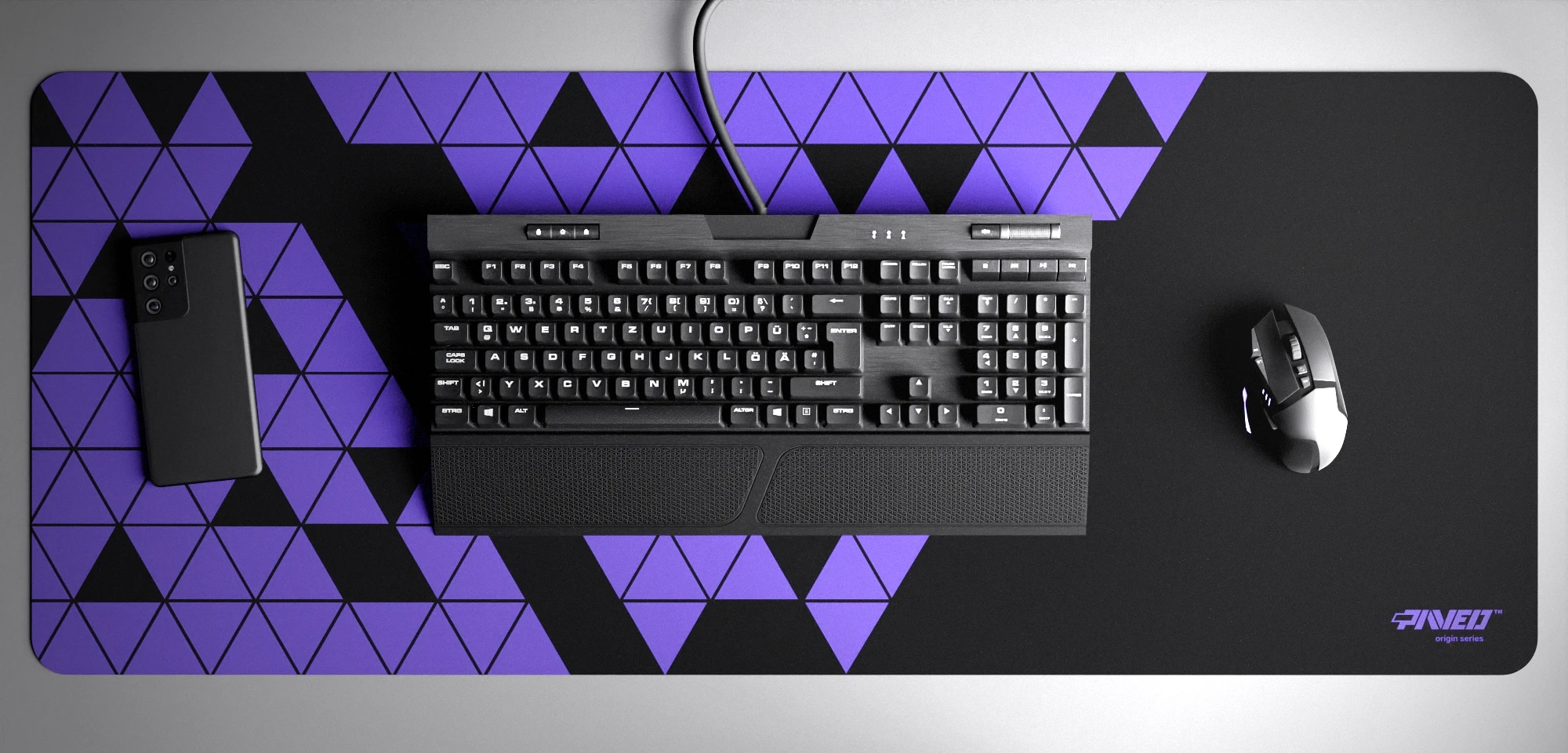 Top view of Night Amethyst Prism XXL deskmat 1000mm x 400mm right-handed variant with minimalistic geometric triangular prism pattern in purple and black, hydrophobic easy-to-clean antimicrobial surface, shown with full-size mechanical keyboard, gaming mouse, and smartphone for scale, 600% lighter non-slip base with no rubbery smell, durable stitch-free edges.