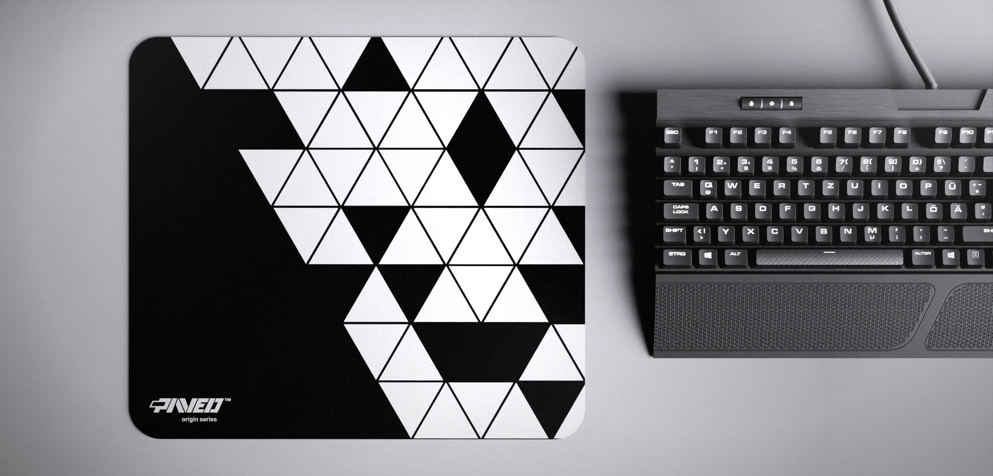 Top view of Night Prism M size mousepad 360mm x 320mm left-handed variant with minimalistic white triangular prism pattern on black background, water-resistant antimicrobial polyester surface, shown with full-size mechanical keyboard for scale, ultra-lightweight odour-free AreoFlex base, stitch-free edges.