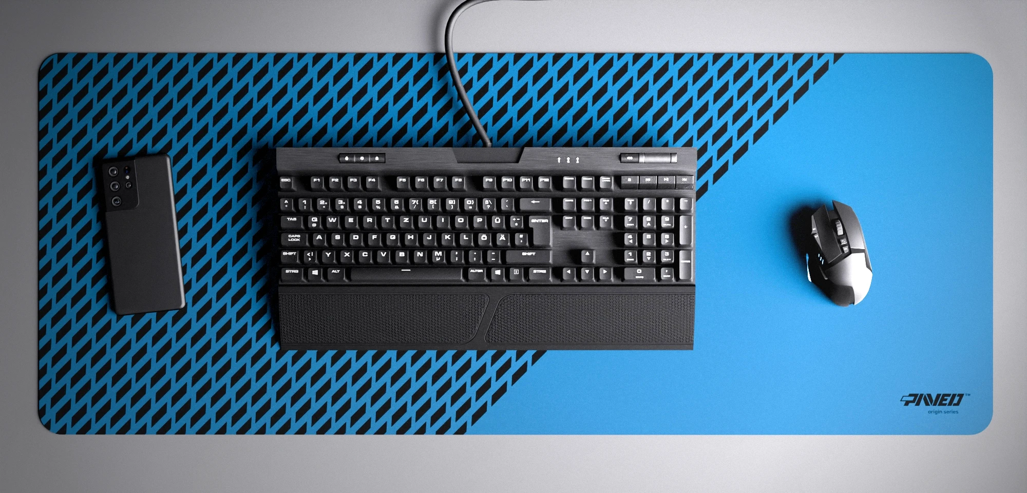 Top view of Sky Panther XXL deskmat 1000mm x 400mm right-handed variant with minimalistic diagonal split design and geometric panther spot pattern in blue and black, hydrophobic easy-to-clean antimicrobial surface, shown with full-size mechanical keyboard, gaming mouse, and smartphone for scale, 600% lighter non-slip base with no rubbery smell, durable stitch-free edges.