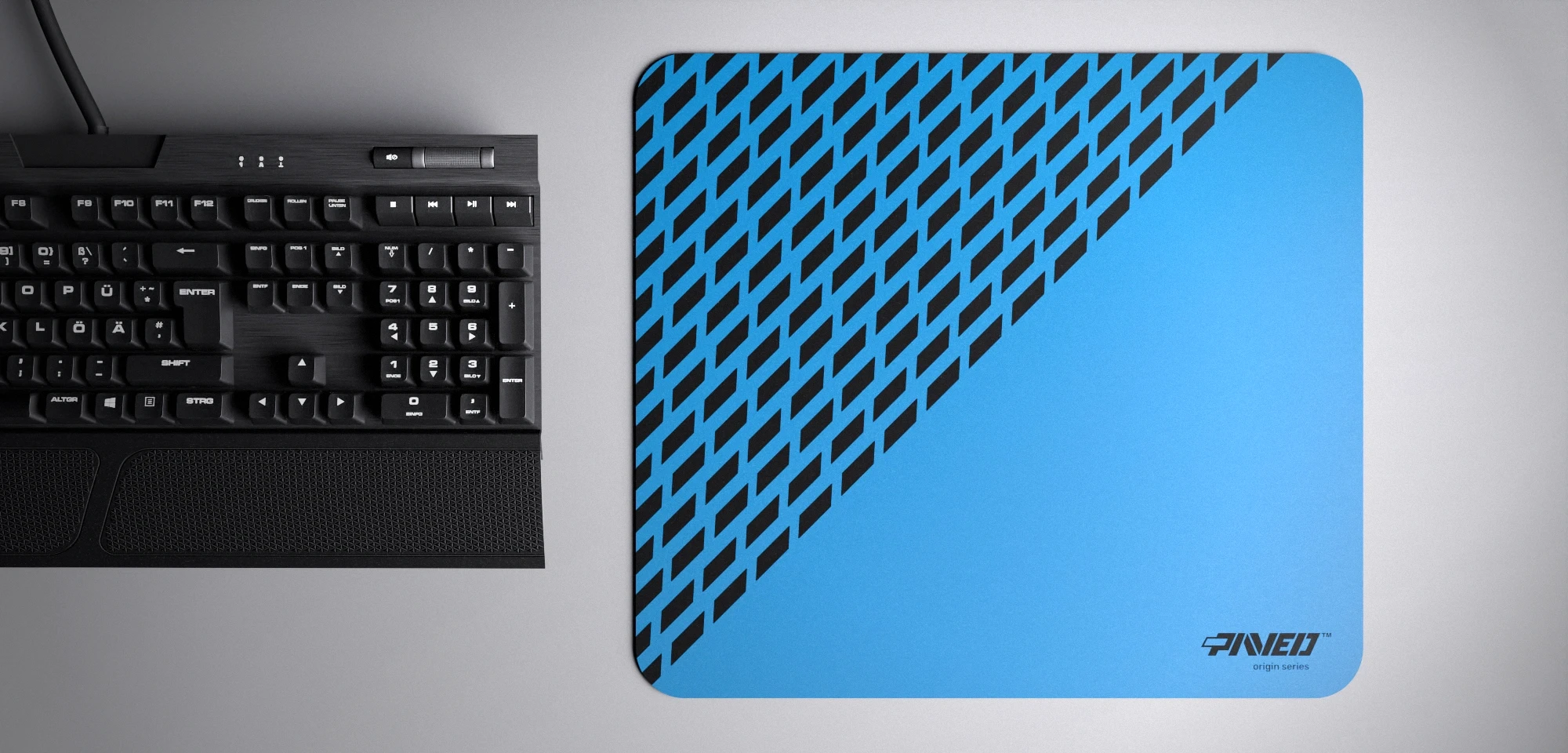 Top view of Sky Panther M size mousepad 360mm x 320mm right-handed variant with diagonal split design and geometric panther spot pattern in blue and black, hydrophobic easy-to-clean surface with antimicrobial properties, shown with full-size mechanical keyboard for scale, 600% lighter with no rubbery odour base, durable stitch-free finish.