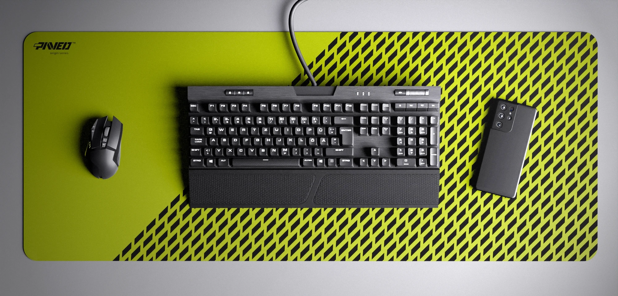 Top view of Toxic Panther XXL deskmat 1000mm x 400mm left-handed variant featuring diagonal split design with geometric panther spot pattern in light green and black, water-resistant antimicrobial polyester surface, shown with full-size mechanical keyboard, gaming mouse, and smartphone for scale, ultra-lightweight odour-free AreoFlex microruber base, stitch-free professional finish.