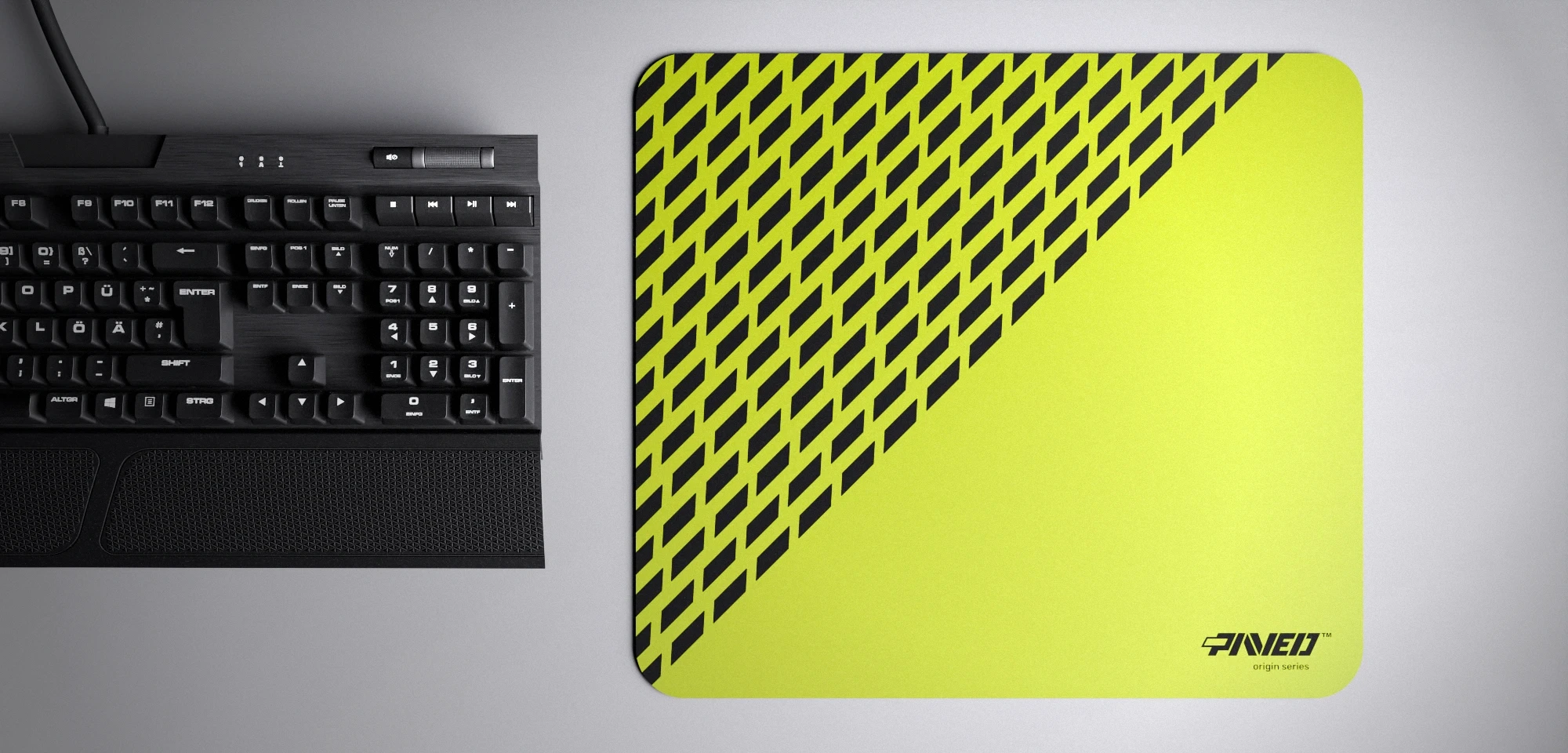 Top view of Toxic Panther M size mousepad 360mm x 320mm right-handed variant with diagonal split design and geometric panther spot pattern in light green and black, hydrophobic easy-to-clean surface with antimicrobial properties, shown with full-size mechanical keyboard for scale, 600% lighter with no rubbery odour base, durable stitch-free finish.