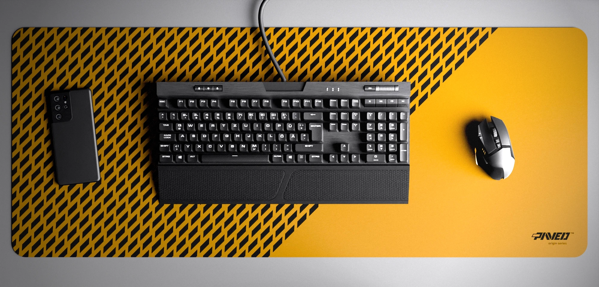 Top view of Desert Panther XXL deskmat 1000mm x 400mm right-handed variant with minimalistic diagonal split design and geometric panther spot pattern in deep yellow and black, hydrophobic easy-to-clean antimicrobial surface, shown with full-size mechanical keyboard, gaming mouse, and smartphone for scale, 600% lighter non-slip base with no rubbery smell, durable stitch-free edges.
