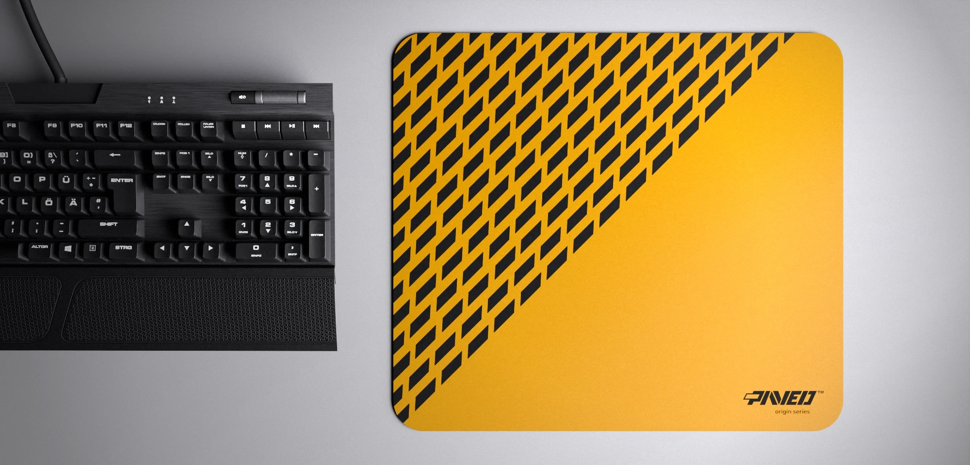Top view of Desert Panther M size mousepad 360mm x 320mm right-handed variant with diagonal split design and geometric panther spot pattern in deep yellow and black, hydrophobic easy-to-clean surface with antimicrobial properties, shown with full-size mechanical keyboard for scale, 600% lighter with no rubbery odour base, durable stitch-free finish.