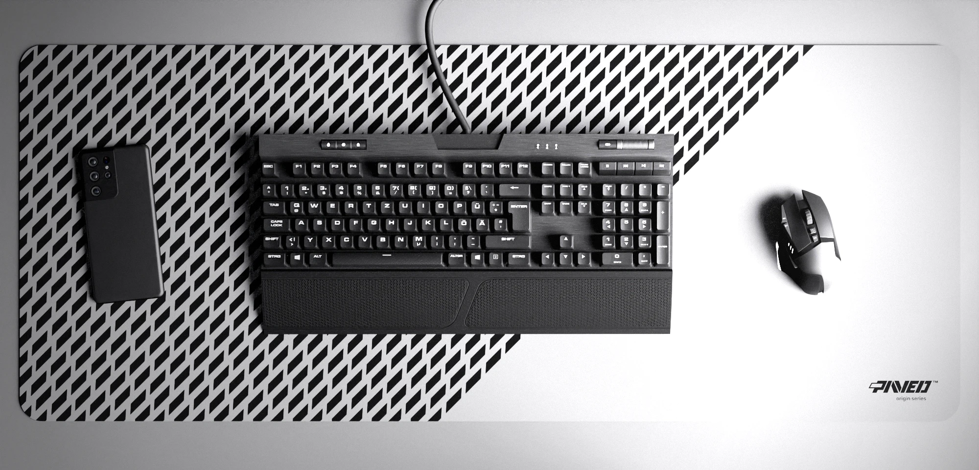 Top view of Polar Panther XXL deskmat 1000mm x 400mm right-handed variant with minimalistic diagonal split design and geometric panther spot pattern in white and black, hydrophobic easy-to-clean antimicrobial surface, shown with full-size mechanical keyboard, gaming mouse, and smartphone for scale, 600% lighter non-slip base with no rubbery smell, durable stitch-free edges.