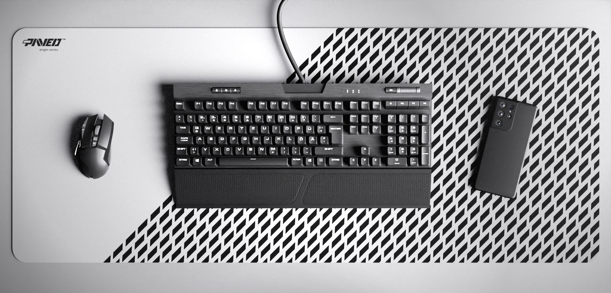 Top view of Polar Panther XXL deskmat 1000mm x 400mm left-handed variant featuring diagonal split design with geometric panther spot pattern in white and black, water-resistant antimicrobial polyester surface, shown with full-size mechanical keyboard, gaming mouse, and smartphone for scale, ultra-lightweight odour-free AreoFlex microruber base, stitch-free professional finish.