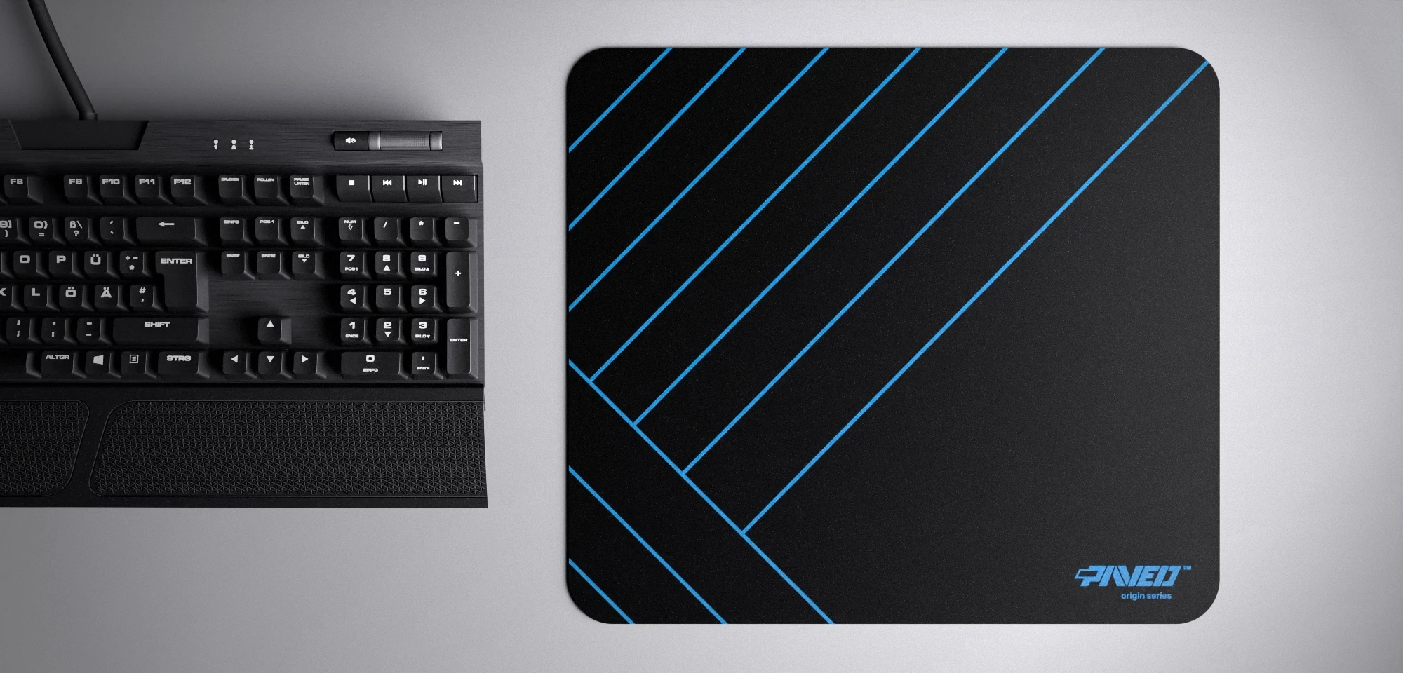 Top view of Night Sky Zebra M size mousepad 360mm x 320mm right-handed variant with diagonal stripe pattern in blue and black, hydrophobic easy-to-clean surface with antimicrobial properties, shown with full-size mechanical keyboard for scale, 600% lighter with no rubbery odour base, durable stitch-free finish.