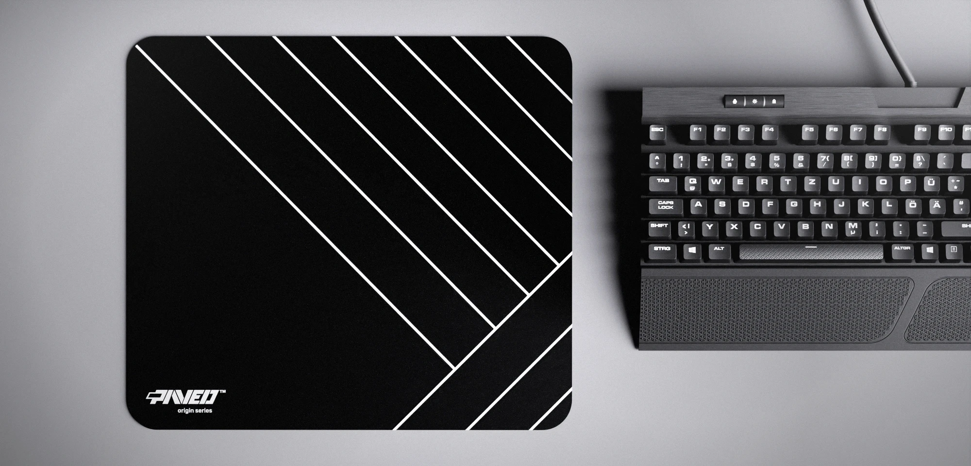 Top view of Night Zebra M size mousepad 360mm x 320mm left-handed variant with minimalistic white diagonal stripe pattern on black background, water-resistant antimicrobial polyester surface, shown with full-size mechanical keyboard for scale, ultra-lightweight odour-free AreoFlex base, stitch-free edges.