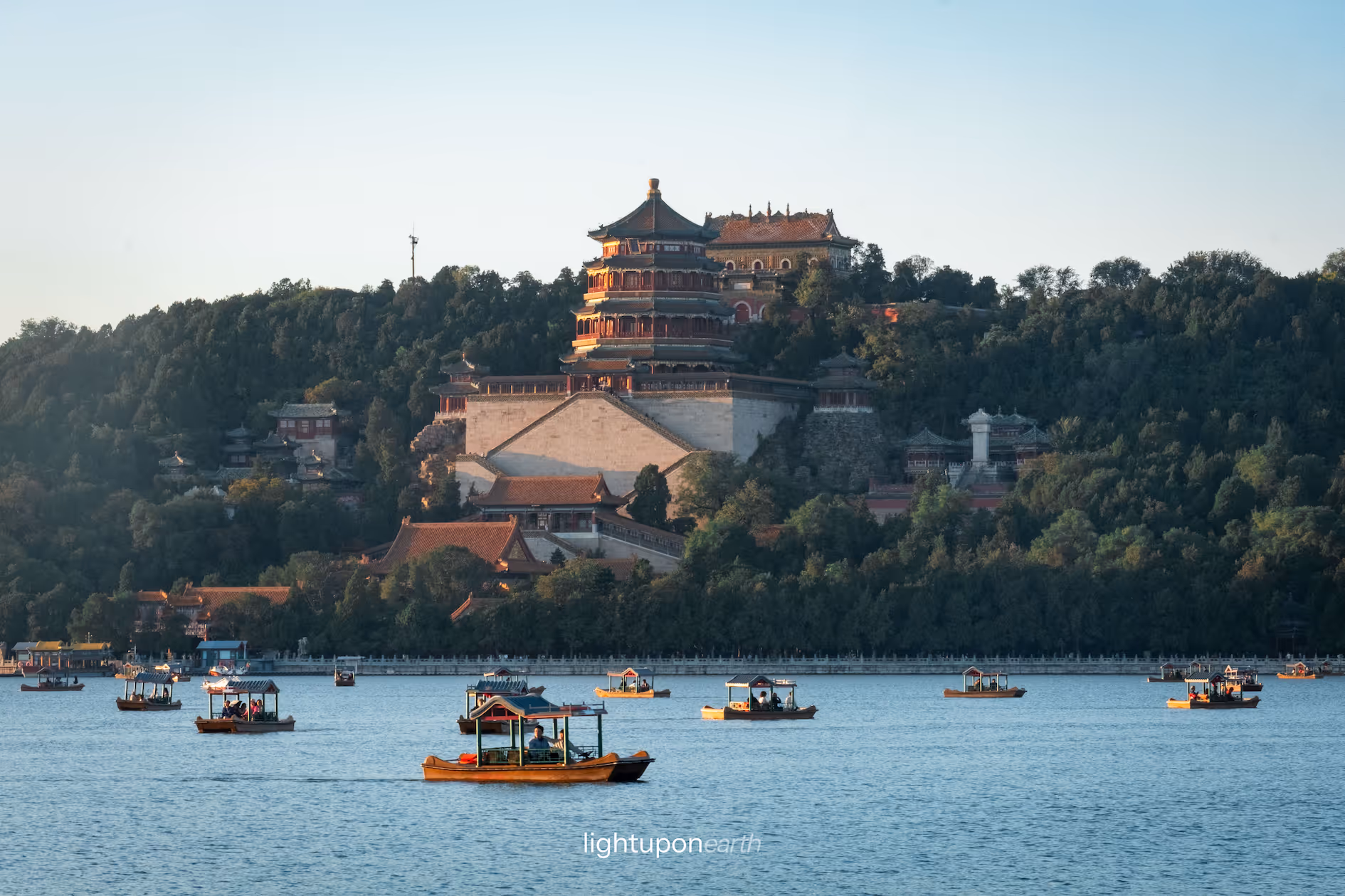 Boats on a lake with the Summer Palace in the background