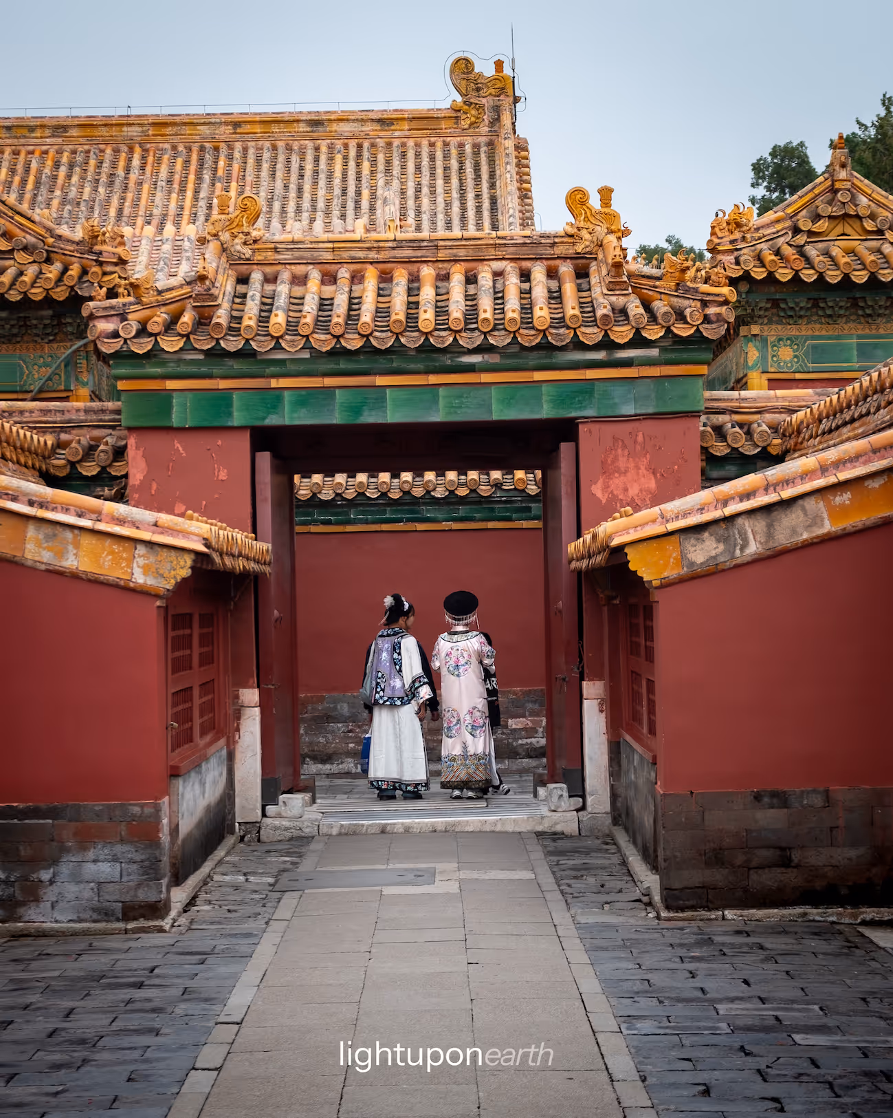 Two women wearing traditional Chinese clothes inside the Forbidden City
