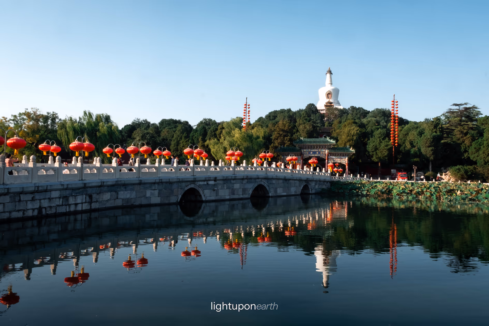 Bridge leading to an island with a white pagoda