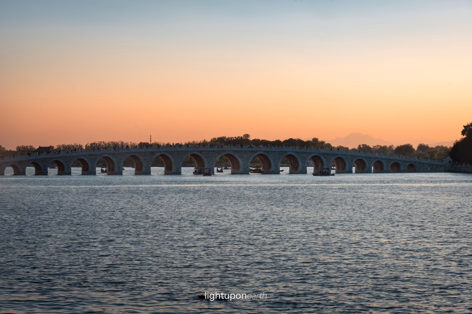 17-arch bridge with sunset in the background