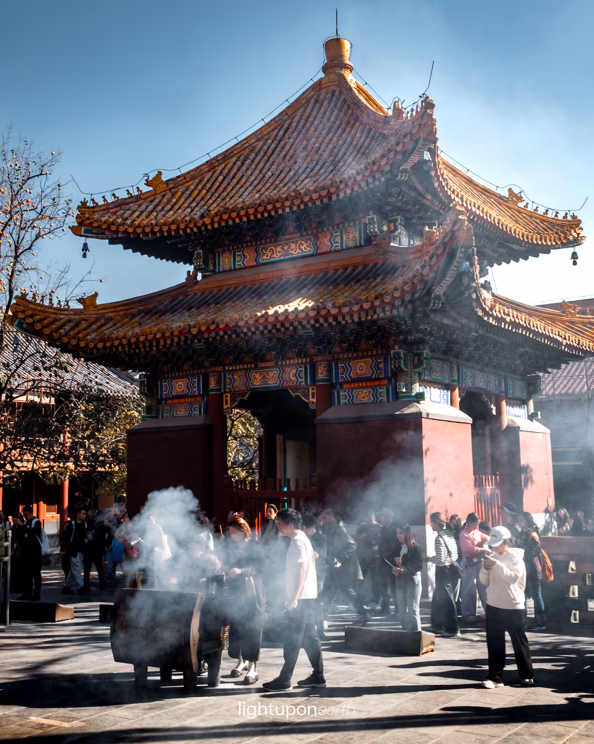 People worshiping and lighting incense sticks at Lama Temple