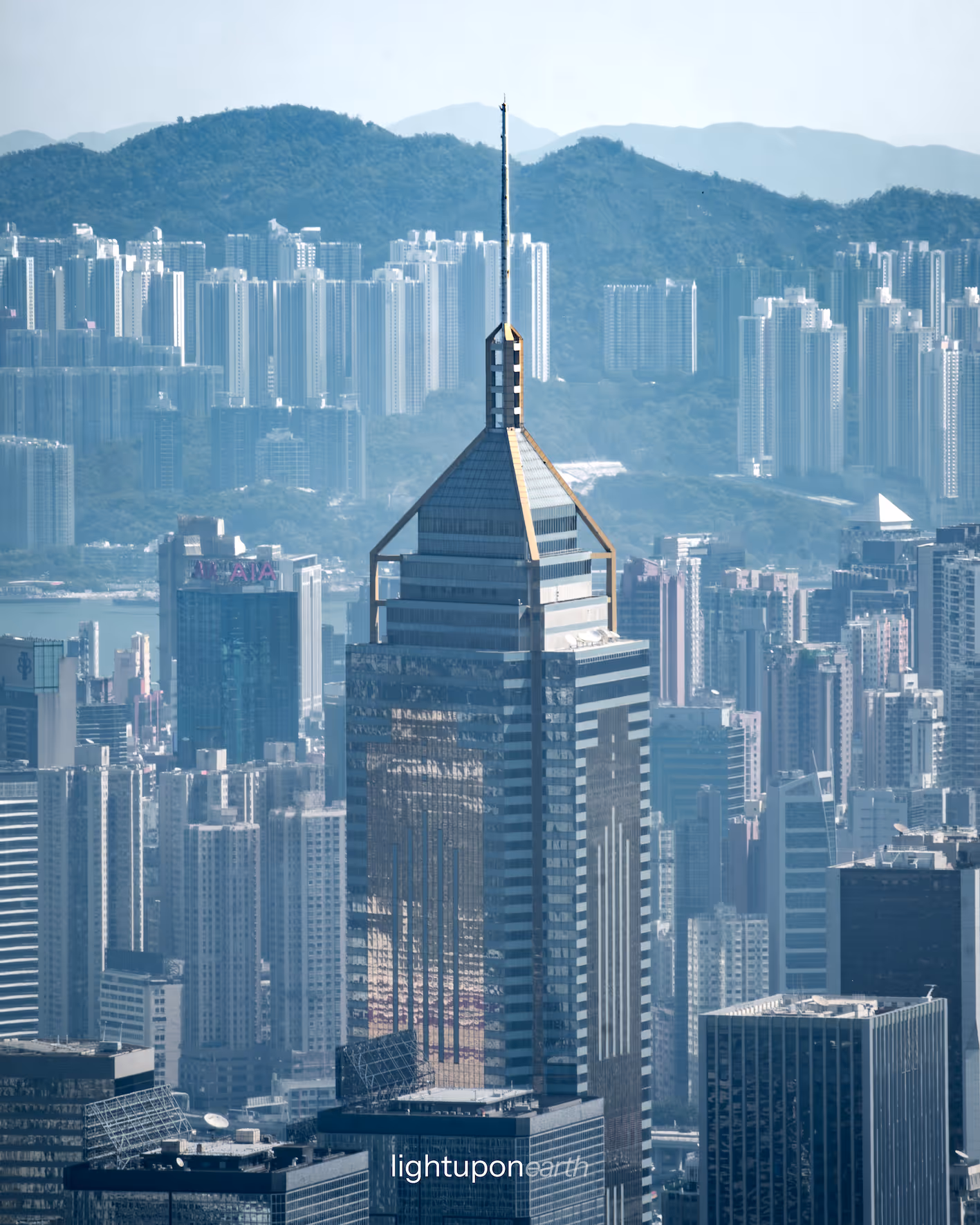 Hong Kong skyscraper with green hills in the background