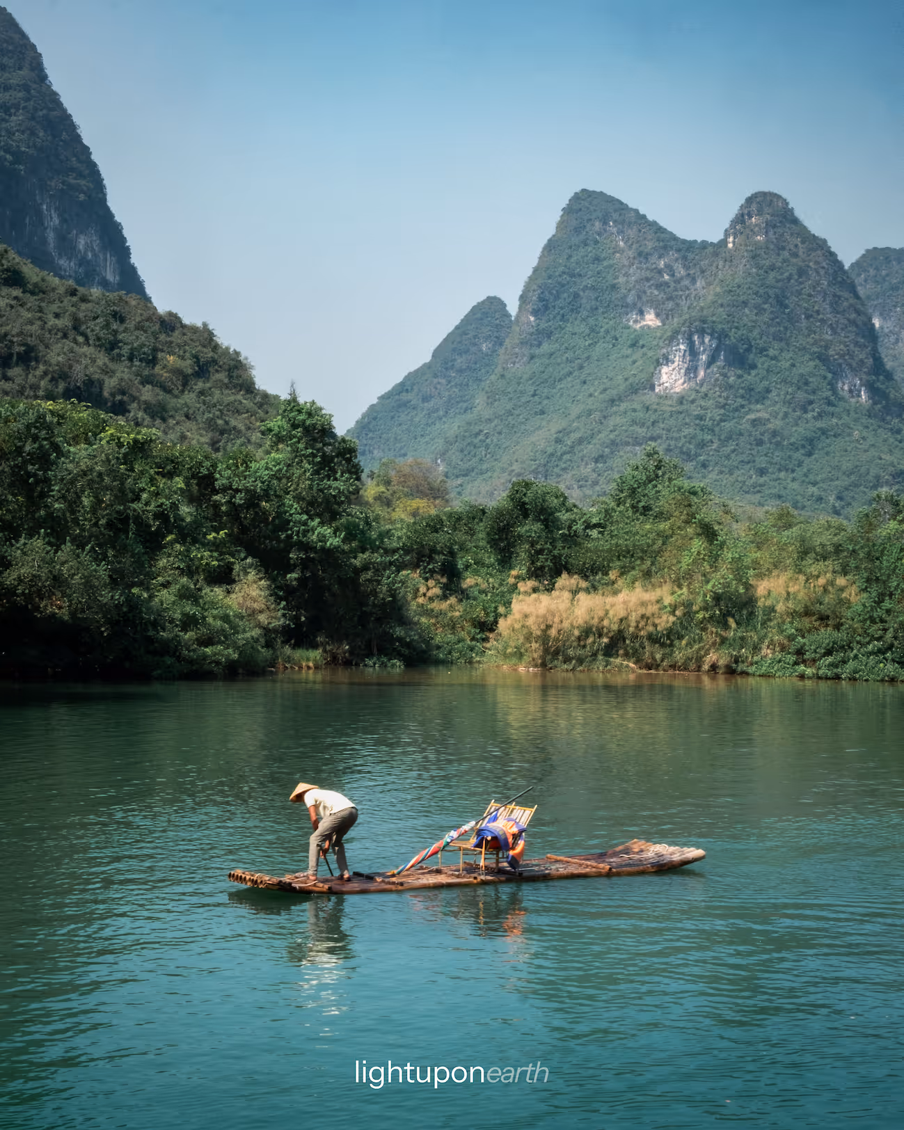 Traditional bamboo raft cruising on Yulong river