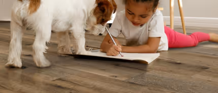 A child and dog on luxury vinyl plank flooring