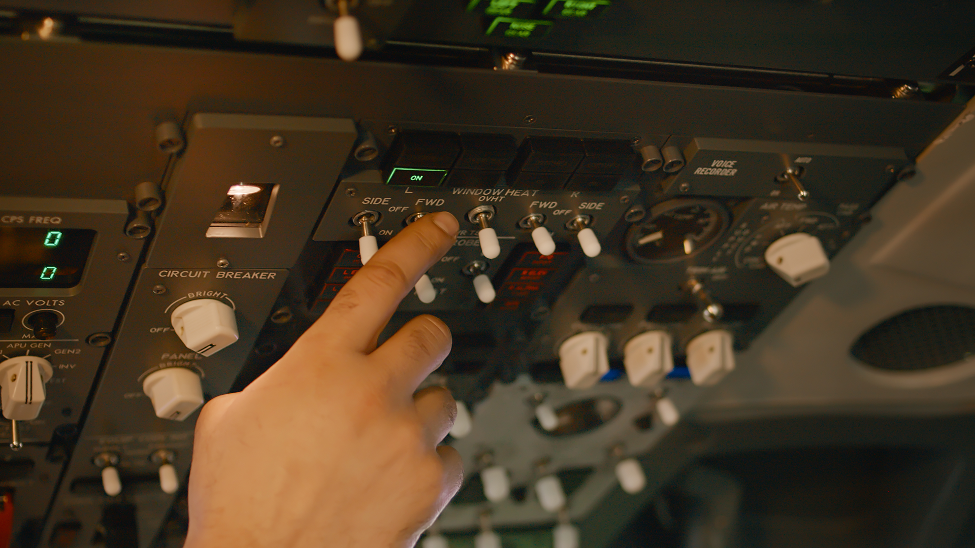 A pilot's hand adjusting overhead cockpit switches, performing routine system checks to extend aircraft component life.