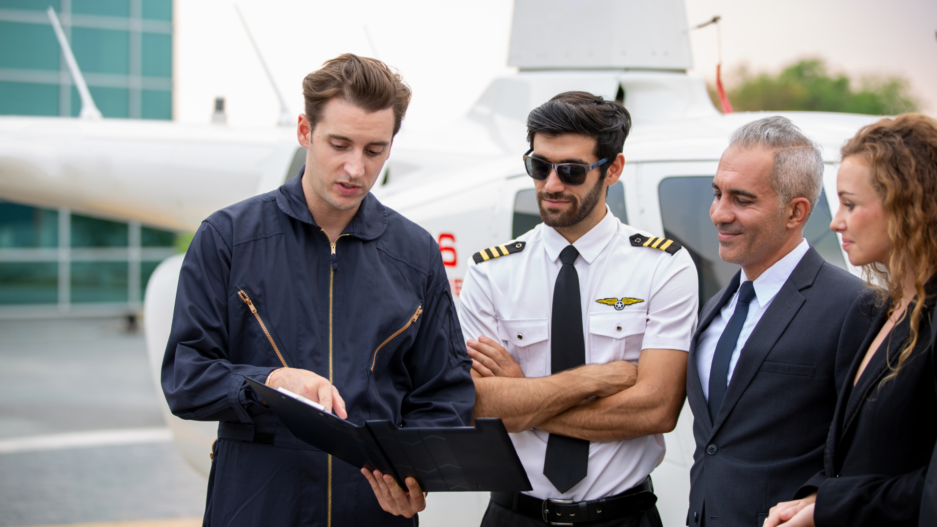 A flight crew and ground personnel standing in front of an aircraft while reviewing a document.