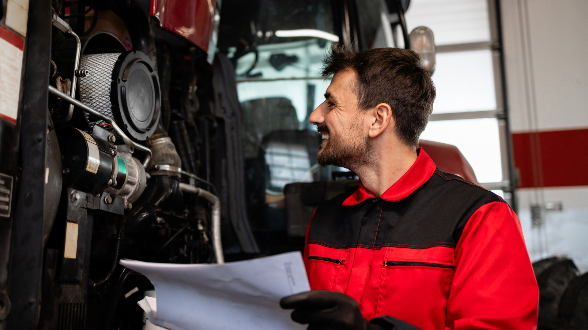 Aircraft mechanic inspecting equipment while reviewing maintenance paperwork for aircraft components.