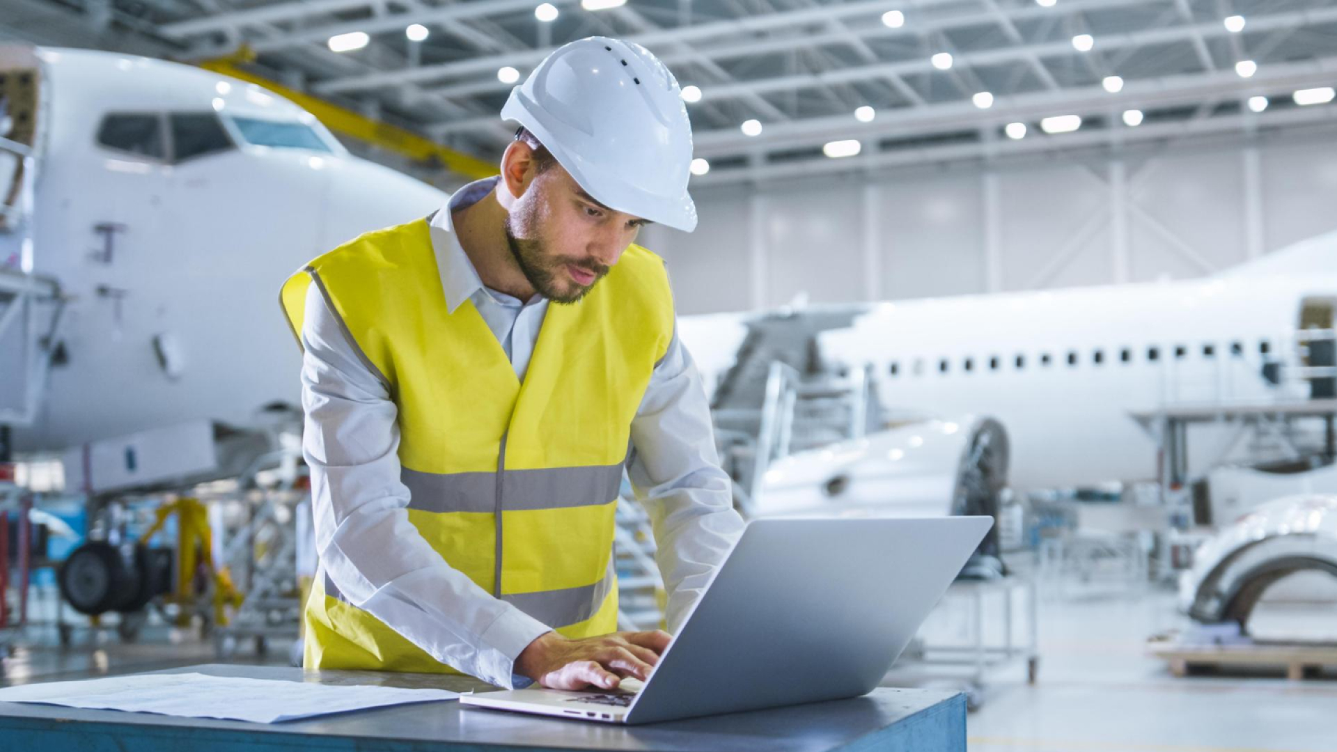 Engineer reviewing operational data on a computer, illustrating analysis of supply chain risk and parts traceability issues.