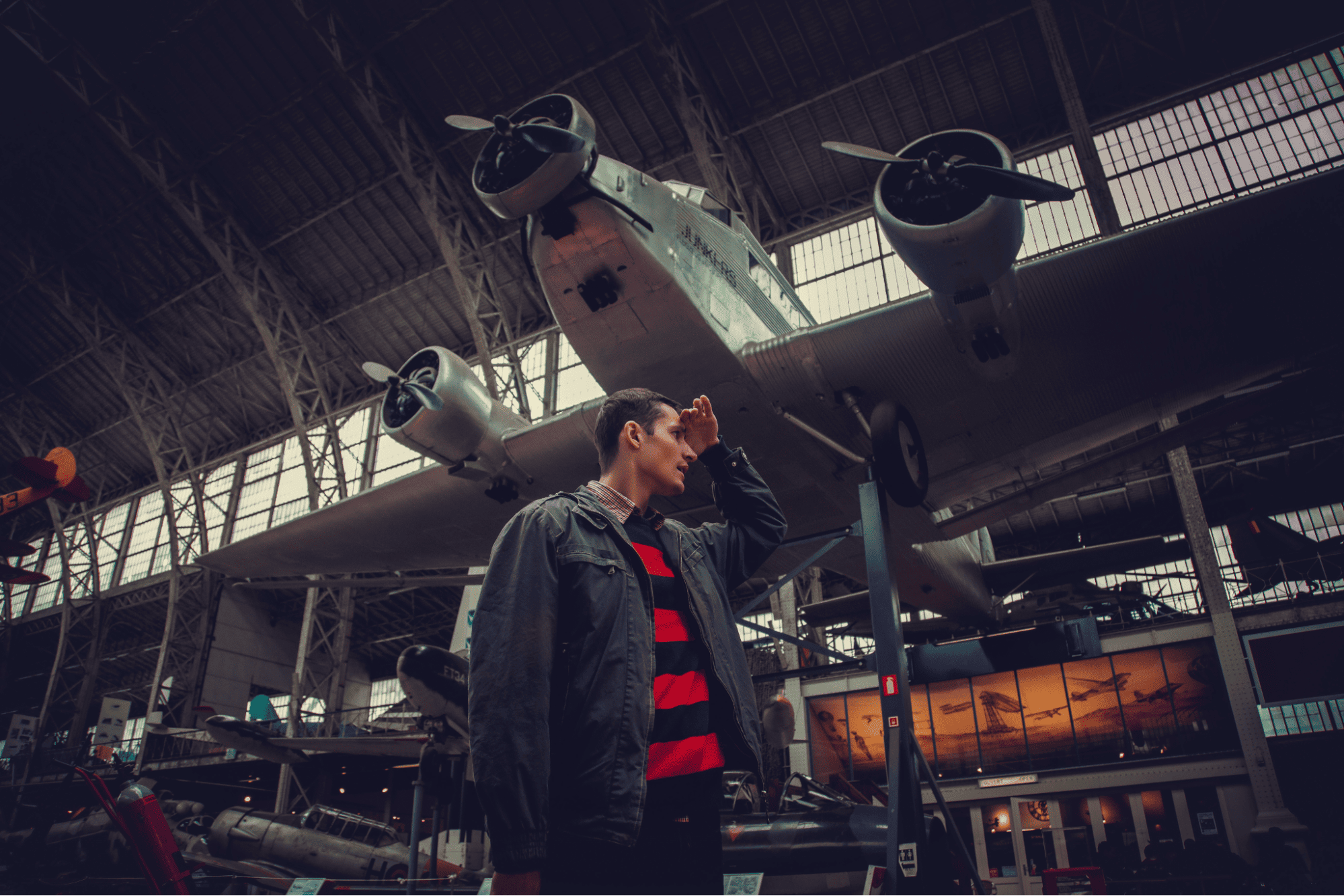 Aircraft mechanic in maintenance hangar inspecting aircraft systems during routine maintenance work.