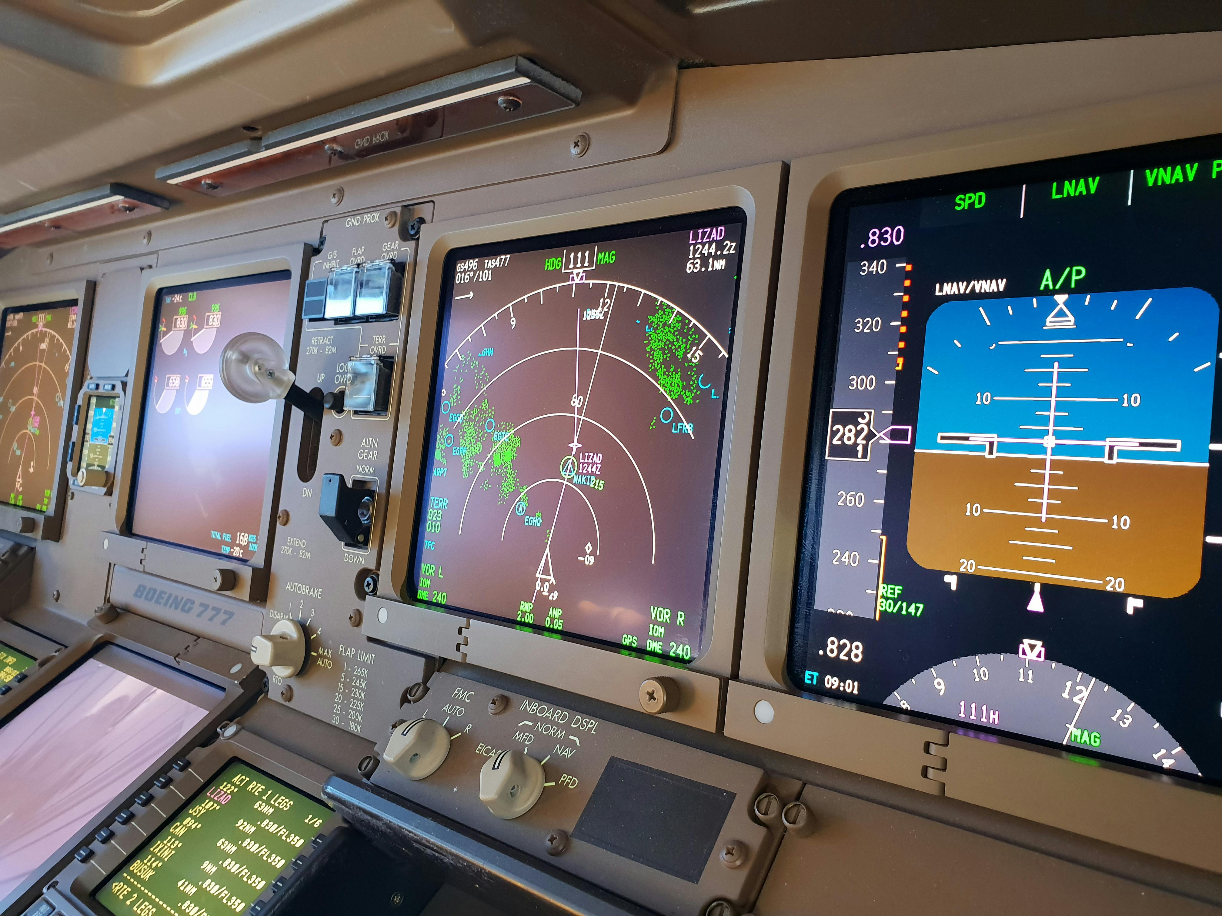 Aircraft display screens showing navigation data, radar readings, and flight parameters.