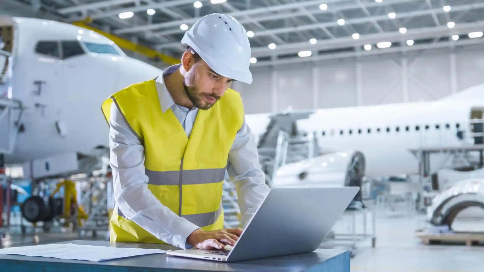 Engineer reviewing operational data on a computer, illustrating analysis of supply chain risk and parts traceability issues.