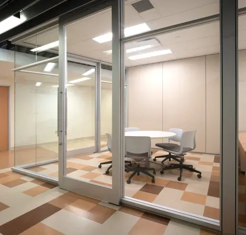 Meeting room with circular table and office chairs positioned around it