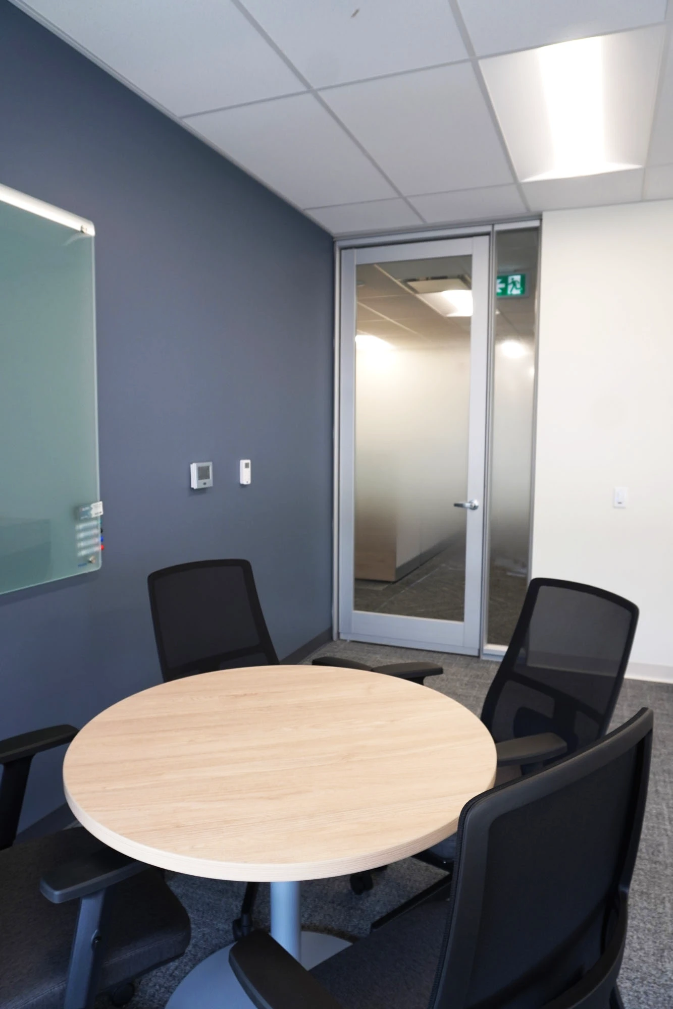 Meeting room interior with round meeting table and office chairs
