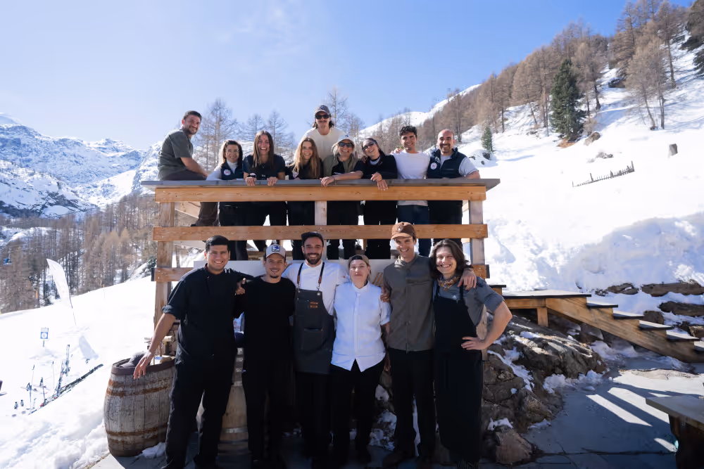 Full team of Restaurant Marmo Furi and Chalet Furi posed on the alpine terrace in Zermatt
