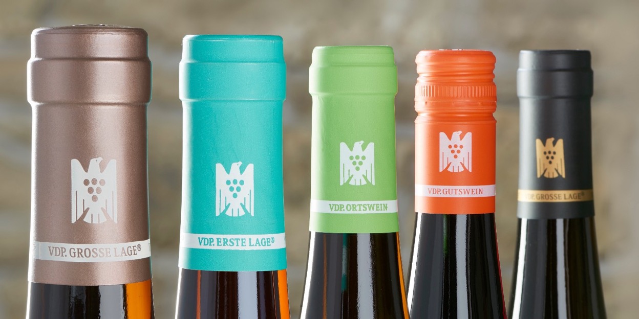 An image of the tops of wine bottles
