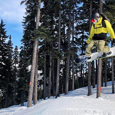 Bryn mid-air, snowboarding in Whistler