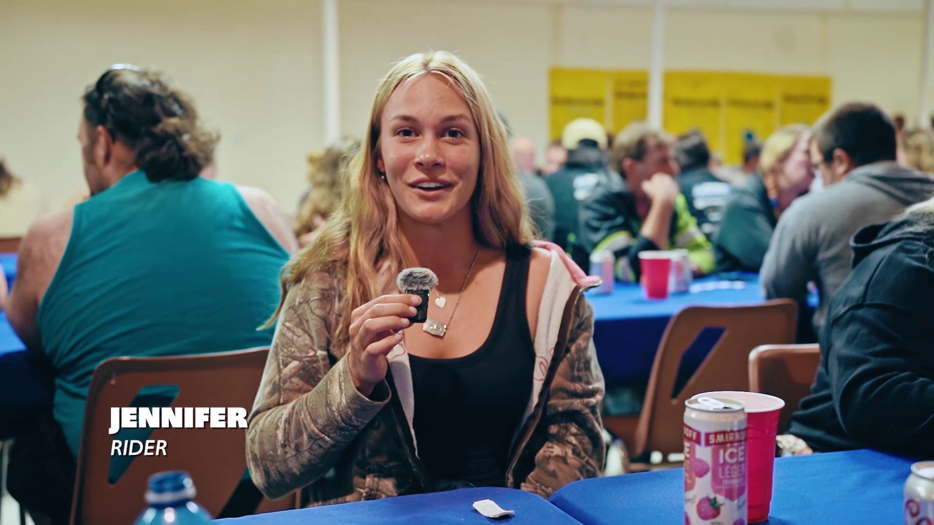 A rider shows her poker run hand at the Jamboree banquet