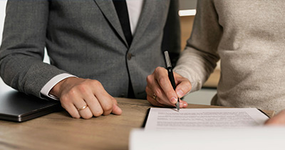 2 people signing a document