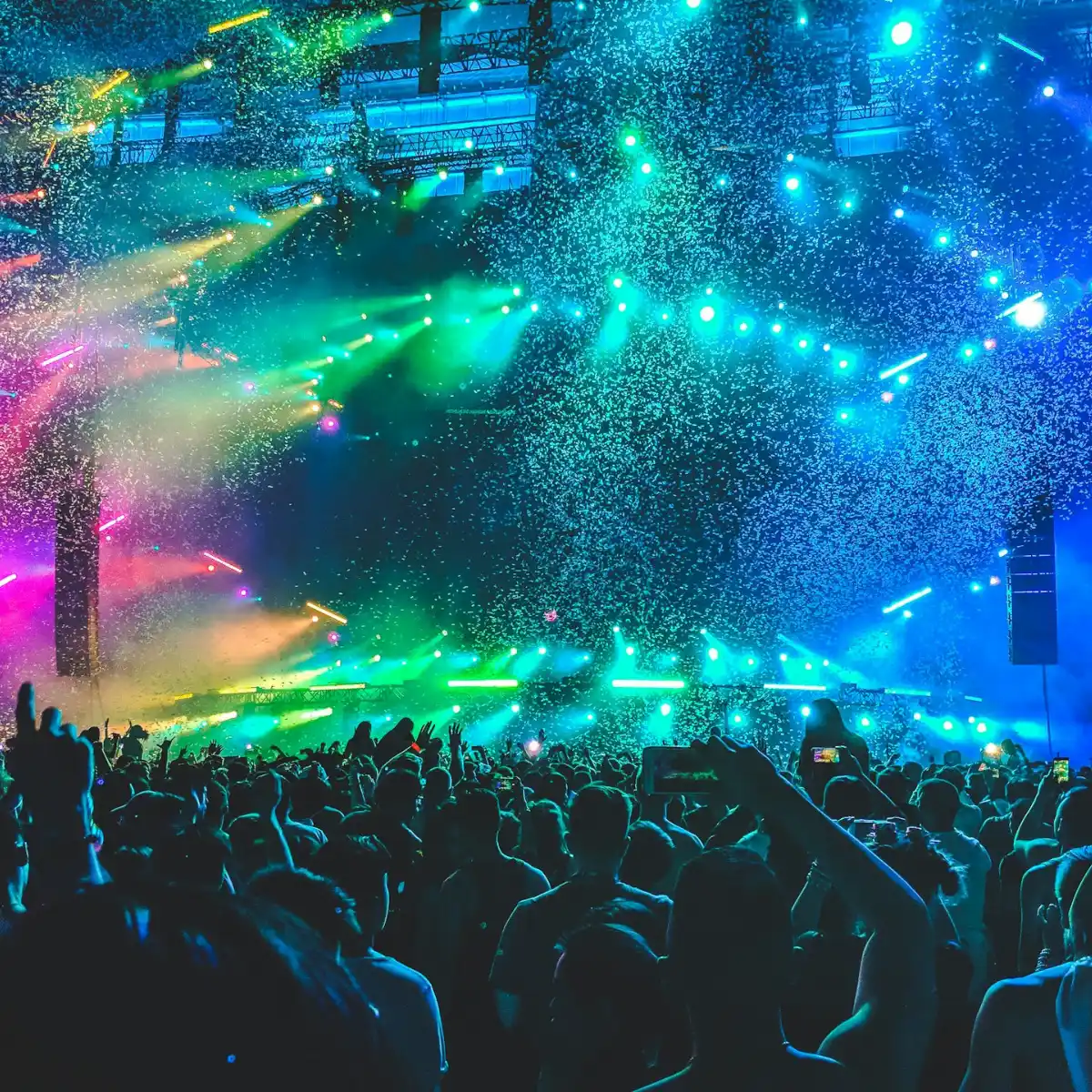 A concert with neon lights and confetti in the air