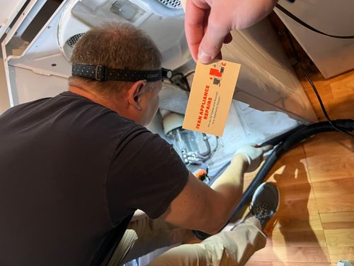 Appliance repair technician repairing refrigerator