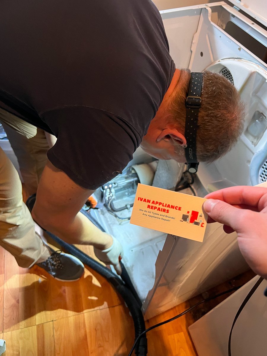 Appliance repair technician repairing a washer