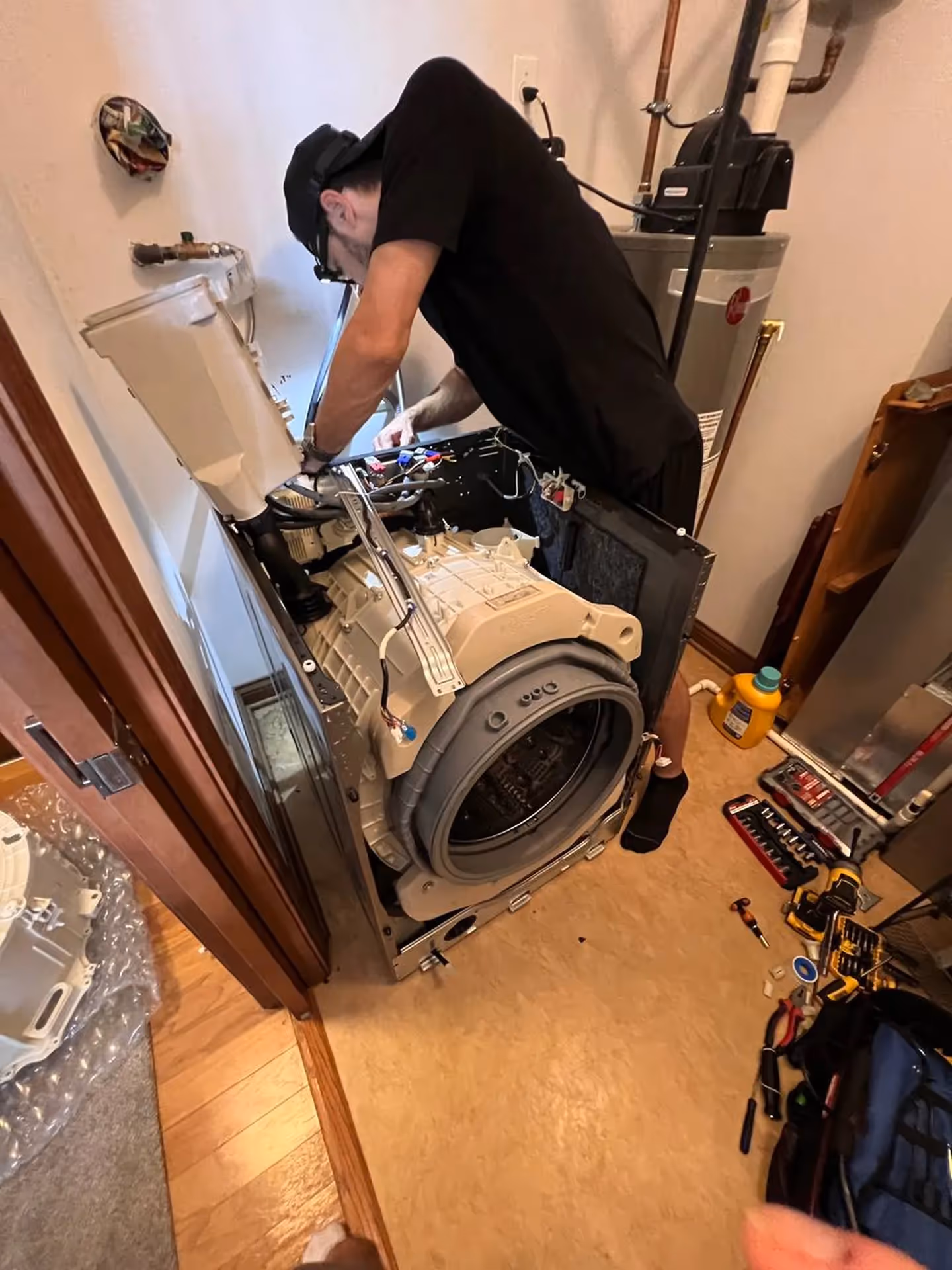 Appliance repair technician repairing a washer