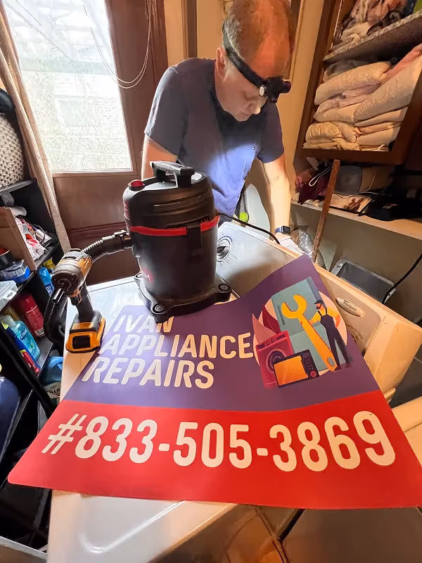 Appliance repair technician repairing a washer